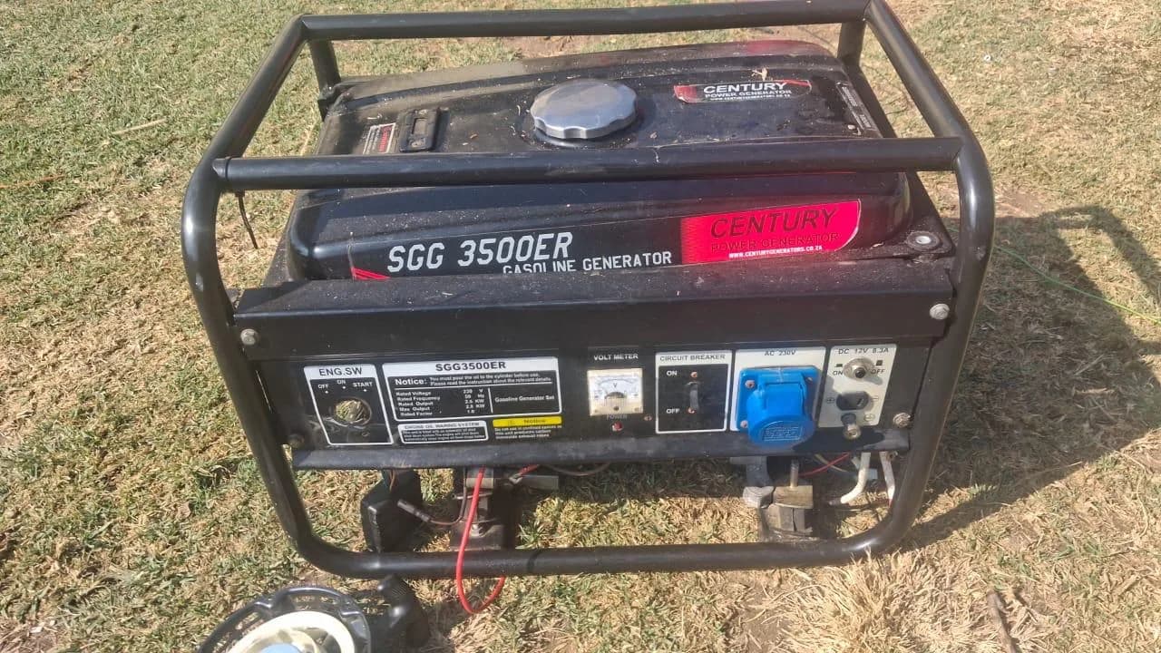 Century SGG 3500ER petrol generator in a black tube frame on dry grass, showing sockets and voltmeter