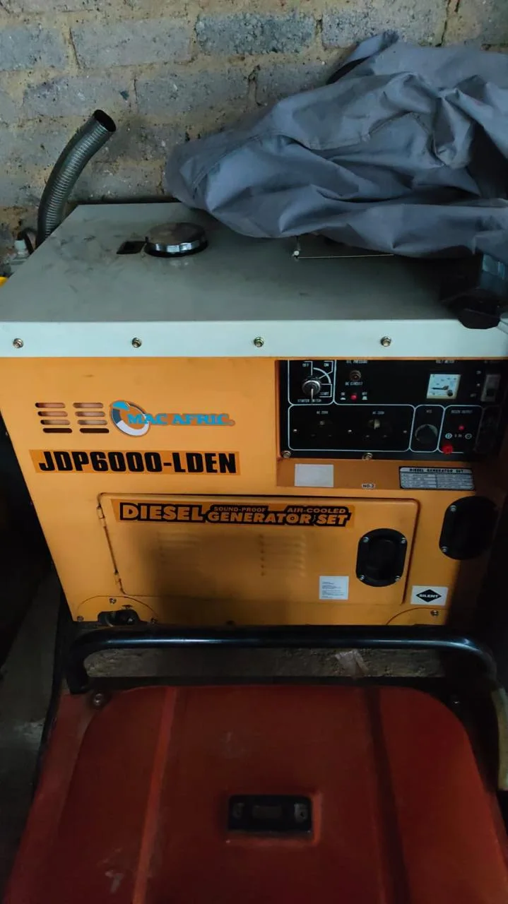 Orange Mac Afric JDP6000-LDEN air-cooled diesel generator with its control panel, a portable unit in front