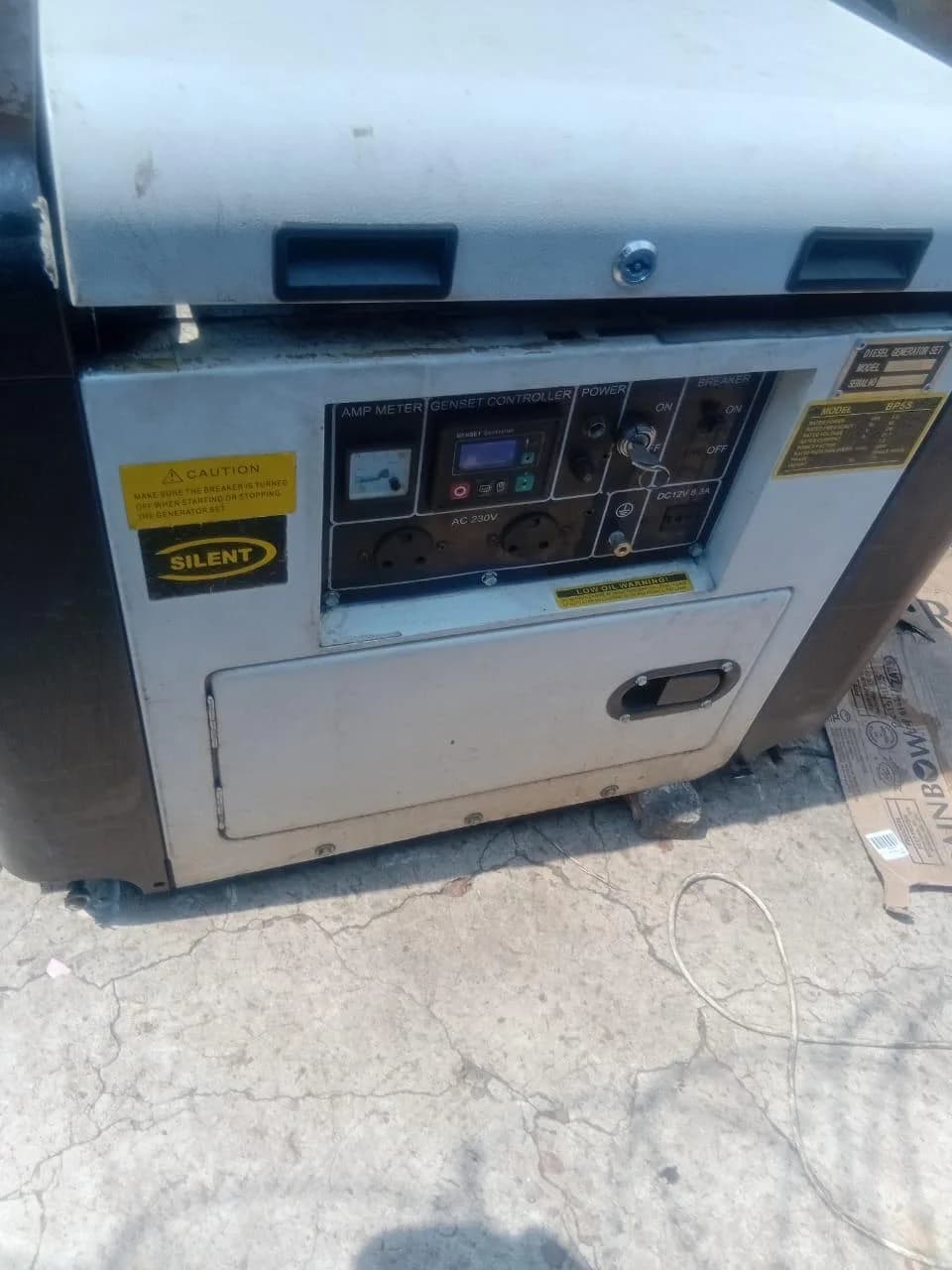 Control panel of a small silent diesel generator with amp meter, genset controller, key switch and 230 V sockets