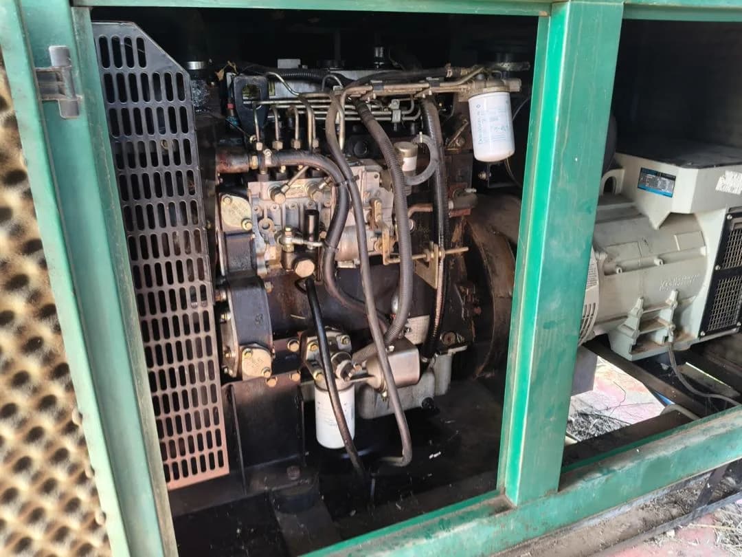 Weathered multi-cylinder diesel engine with injection pump, fuel lines and filter inside an open green canopy