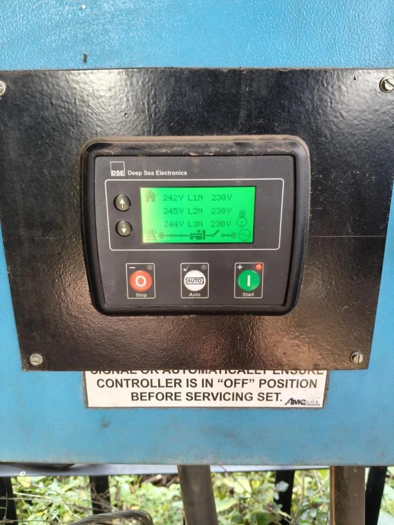 Deep Sea Electronics controller showing about 245 V on each of three phases, with Stop, Auto and Start buttons
