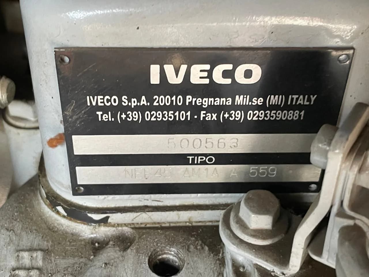 Iveco engine identification plate with serial number and NEF45 type code on a grey engine block