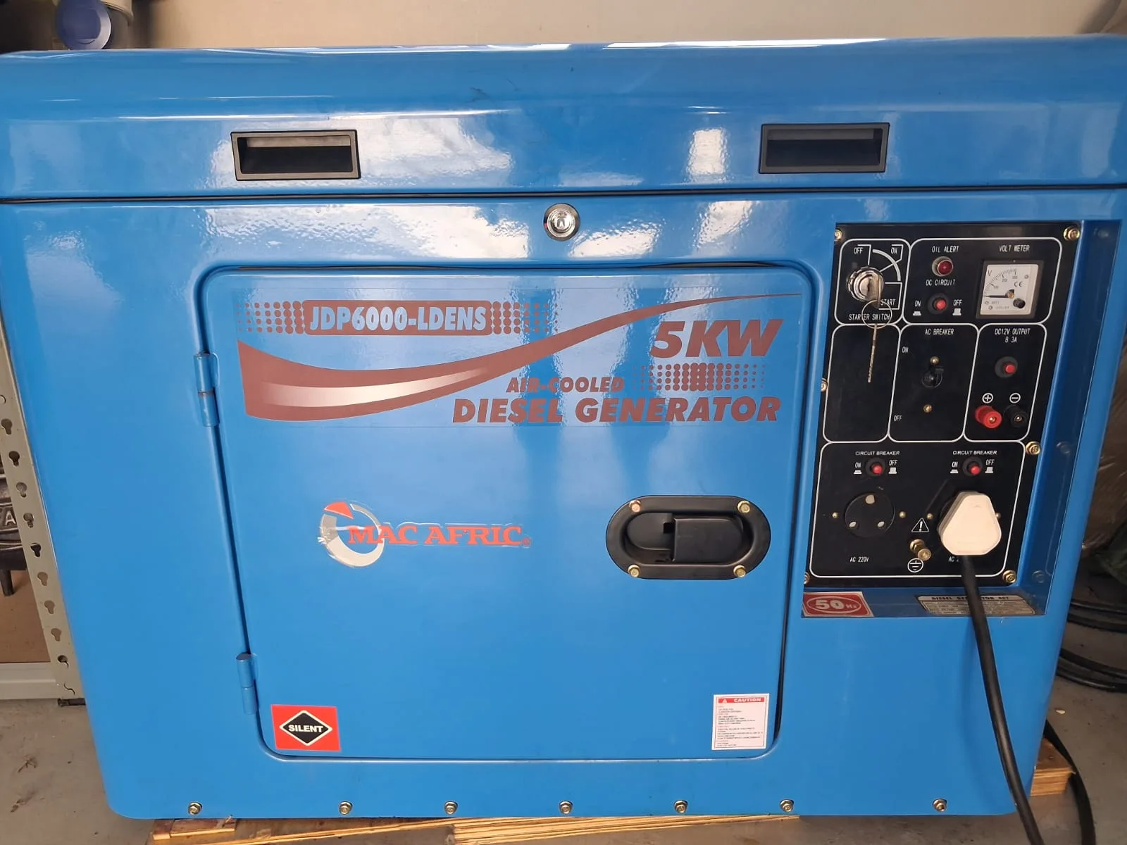 Blue Mac Afric JDP6000-LDENS 5 kW air-cooled silent diesel generator with its control panel and a plug connected