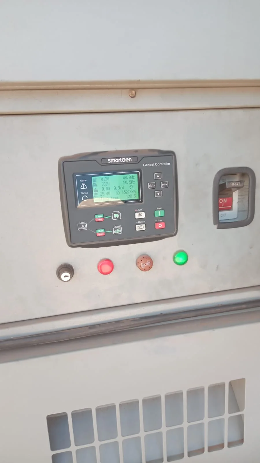 SmartGen controller, indicator lamps and output breaker on a pale grey canopy panel above a louvred vent